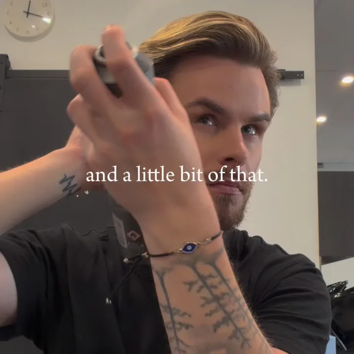 Stylist applying finishing spray to a men’s haircut