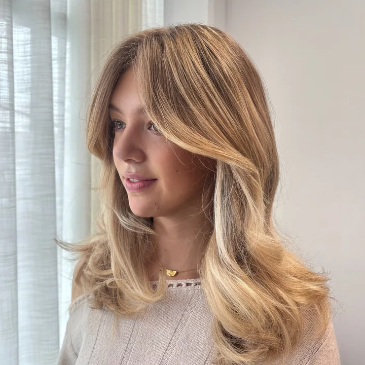 Long blonde layers with softly curved face-framing pieces